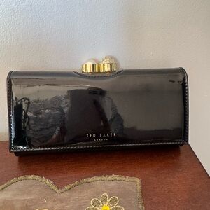 Ted Baker Black Clutch/ wallet with Gold Accents and outside zipper.